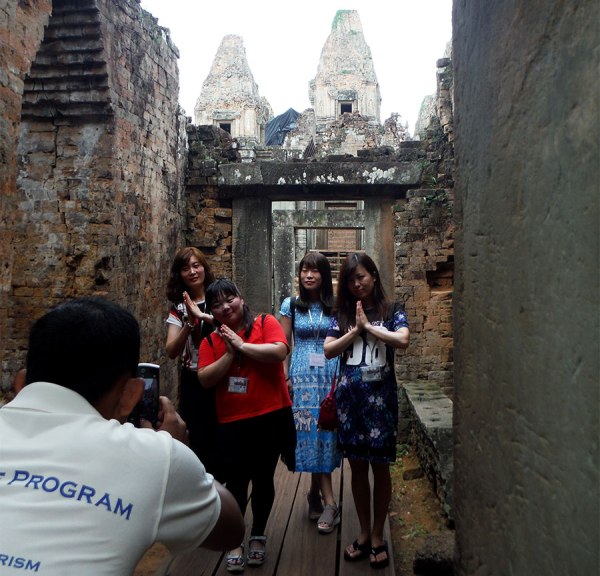 Chinese tourists pose in Angkor Wat
