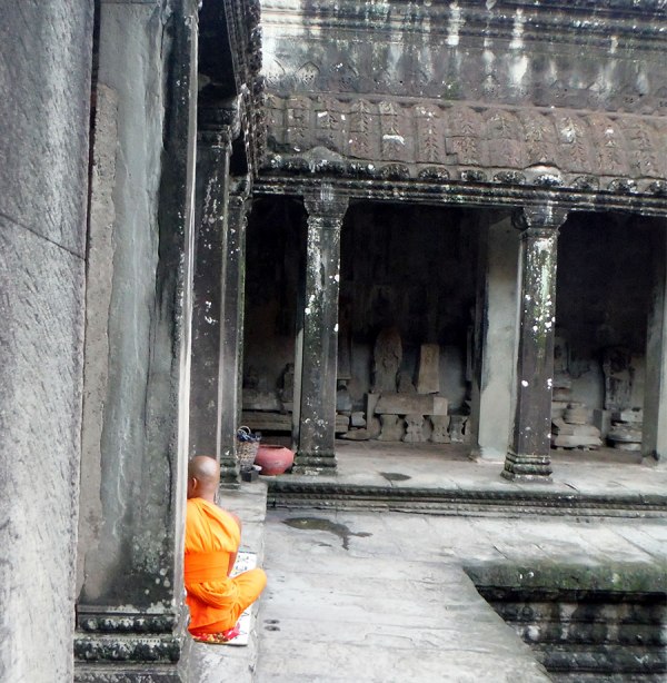 Angkor wat monk waiting to give blessings.